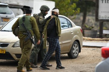 Israeli occupation forces arrest a Palestinian man