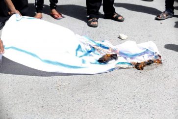 Israeli flag under the feet of Bahraini demonstrators who flood streets in protest over the Kingdom's participation in the funeral of former president of the Zionist entity, Shimon Peres