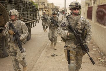 US Army soldiers move down a street as they start a clearing mission in Dora, Iraq, on May 3, 2007, four years before their withdrawal from the country.