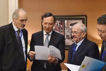 Kazakhstan Foreign Minister Kairat Abdrakhmanov, second from left, speaks with Syrian regime representatives in Astana, Kazakhstan on Sunday.