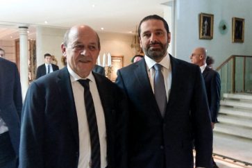 A picture taken with a cell-phone on November 16, 2017, shows French Foreign Minister Jean-Yves Le Drian posing for a photo with Lebanese Prime Minister Saad Hariri in the Saudi capital Riyadh. / AFP PHOTO / Valérie LEROUX