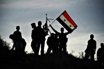Fighters raising Syrian flag