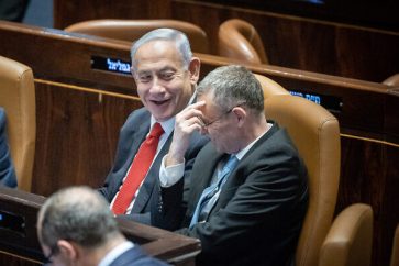 Prime Minister Benjamin Netanyahu, left, and Justice Minister Yariv Levin, right, at the Knesset in Jerusalem, February 20, 2023. (Yonatan Sindel/Flash90)