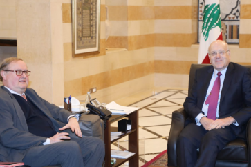 Caretaker Prime Minister Najib Mikati hosting the French Ambassador in charge of coordinating the international aid to Lebanon Pierre Duquesne