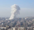 Plumes of smoke billowing from residential edifices in the Mezzeh, Syria