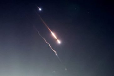 Objects are seen in the sky above Jerusalem after Iran launched drones and missiles towards Israel
