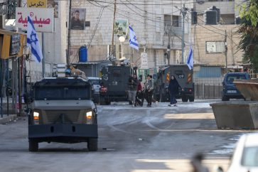 Israeli forces in armoured vehicles conduct a raid in Jenin in the occupied West Bank on January 21, 2025. (Photo by JAAFAR ASHTIYEH / AFP)