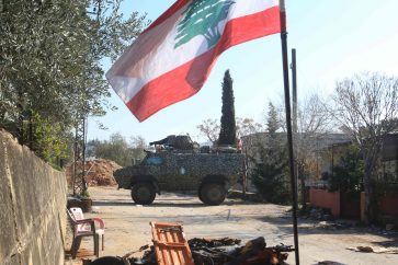 Lebanese army soldiers stand guard at the entrance of the southern Lebanese village of Houla on February 17, 2025. (Photo by Mahmoud ZAYYAT / AFP)