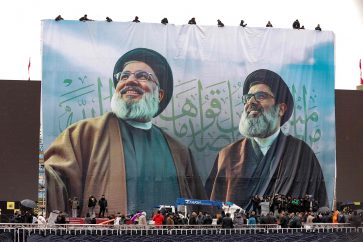 A giant banner bearing the portraits of Hezbollah's slain leader Hassan Nasrallah (L) and  Hashem Safieddine, who was chosen to succeed him before he was also killed, hangs in Beiruts Camil Chamoun sports city on February 22, 2025, as preparations take place a day ahead of their funeral ceremony. Lebanon's Hezbollah is preparing for a massive turnout for the funeral of its slain leader Hassan Nasrallah, an opportunity for a show of strength by the Iran-backed group after a bruising war with Israel. Safieddine will be buried on Monday in his southern hometown of Deir Qanun al-Nahr. (Photo by Ibrahim AMRO / AFP)