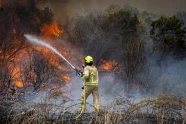 Firefighter trying to extinguish a fire in occupied Al-Quds